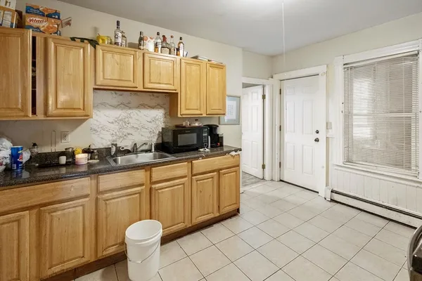 a kitchen with a sink cabinets and appliances