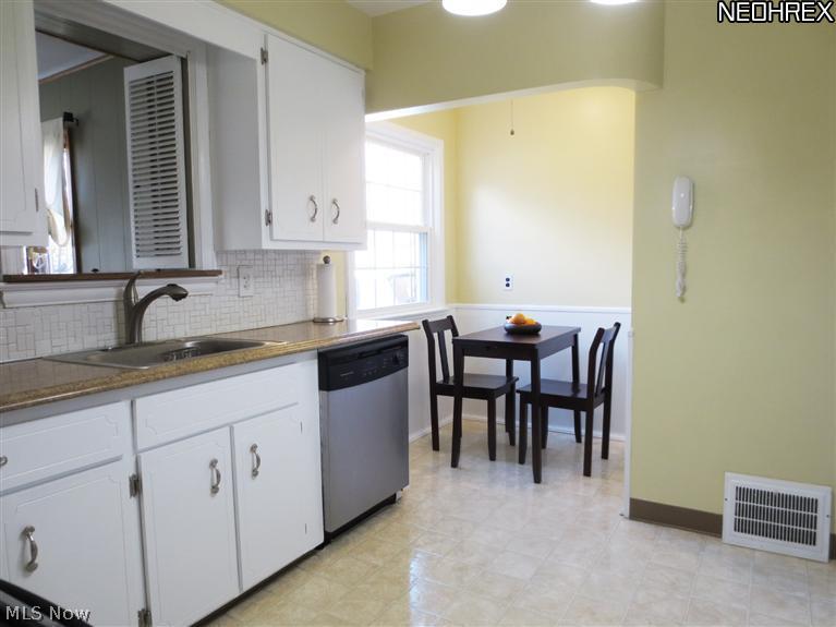 3817 Faversham Road Cleveland, OH 44118 - Photo 5 of 20 Spacious Eat-in Kitchen with White Cabinetry, Newer Counter Tops, and Newer Appliances