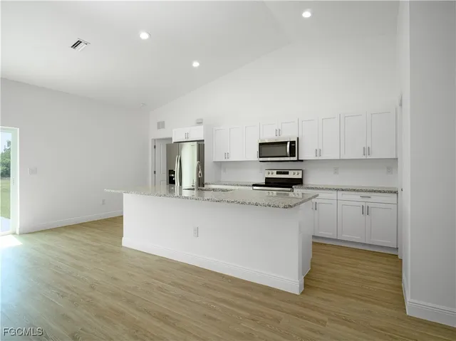 a view of microwave and cabinets