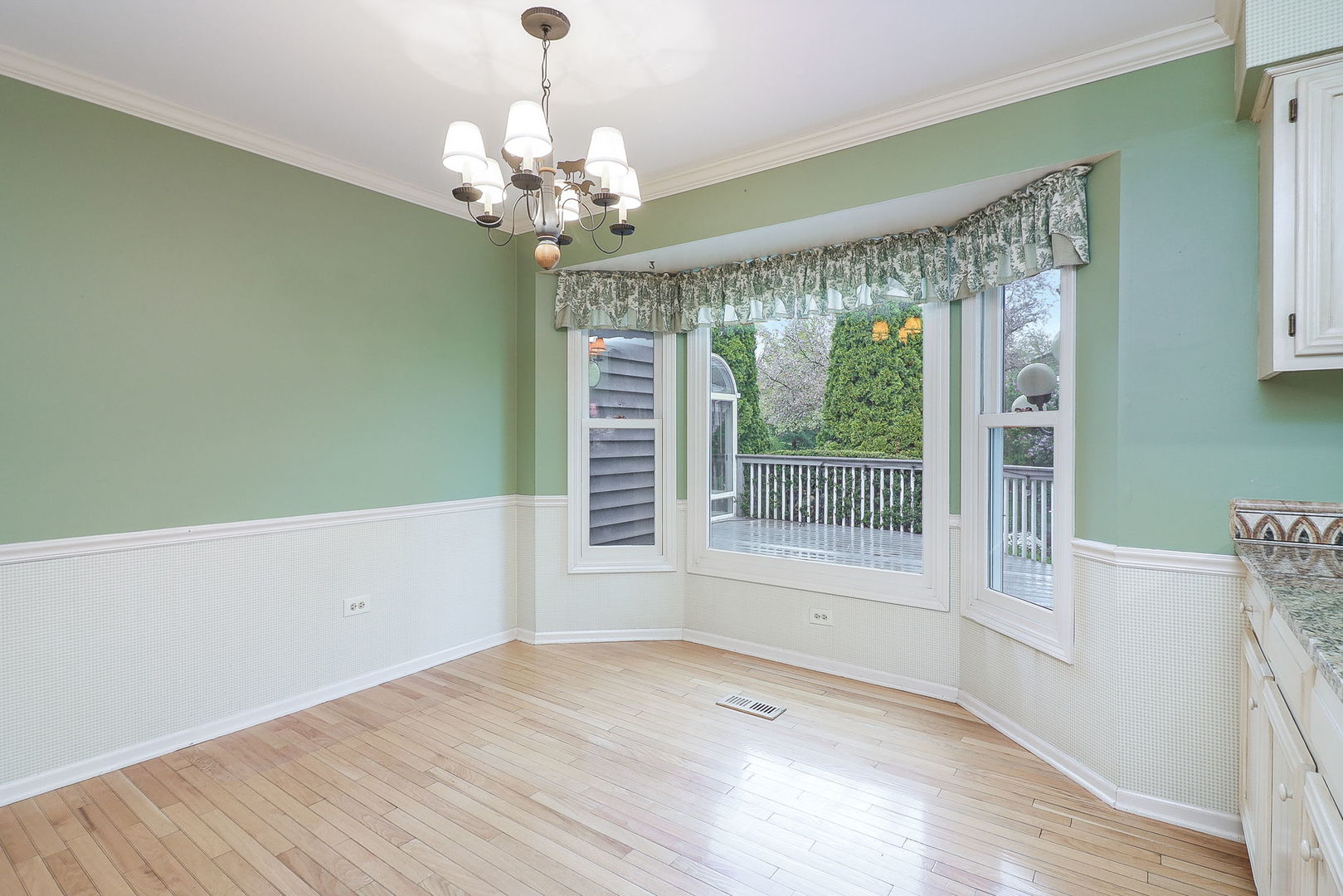 523 Cassin Road Naperville, IL 60565 - Photo 11 of 26 a view of a room with a large window and chandelier