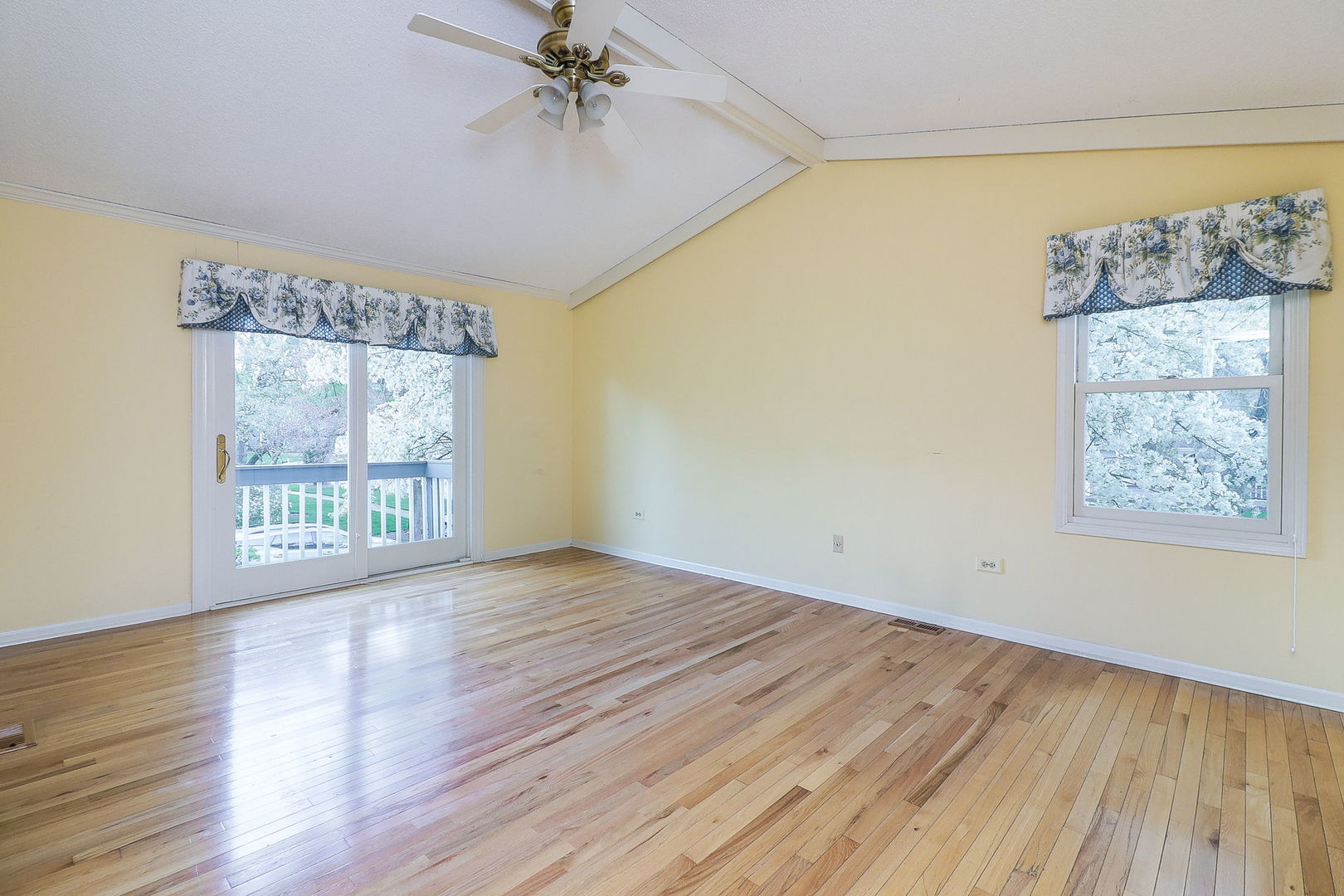 523 Cassin Road Naperville, IL 60565 - Photo 16 of 26 a view of an empty room with wooden floor and a window