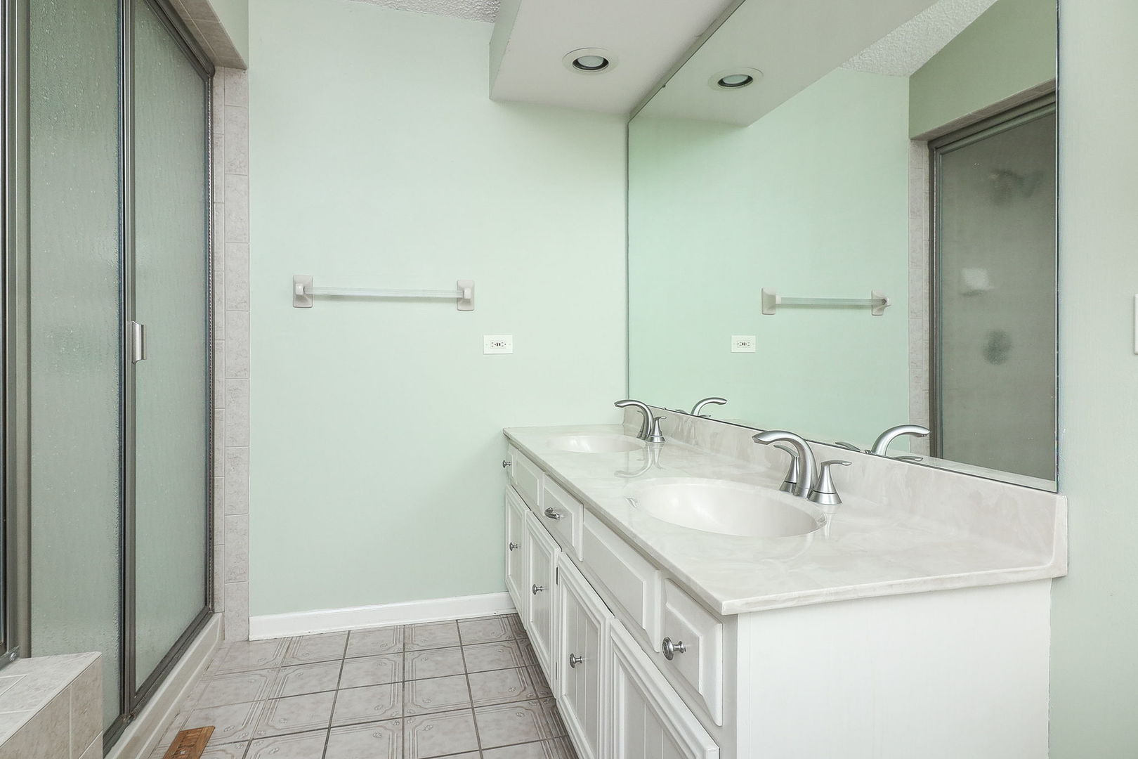 523 Cassin Road Naperville, IL 60565 - Photo 17 of 26 a bathroom with a double vanity sink and a mirror