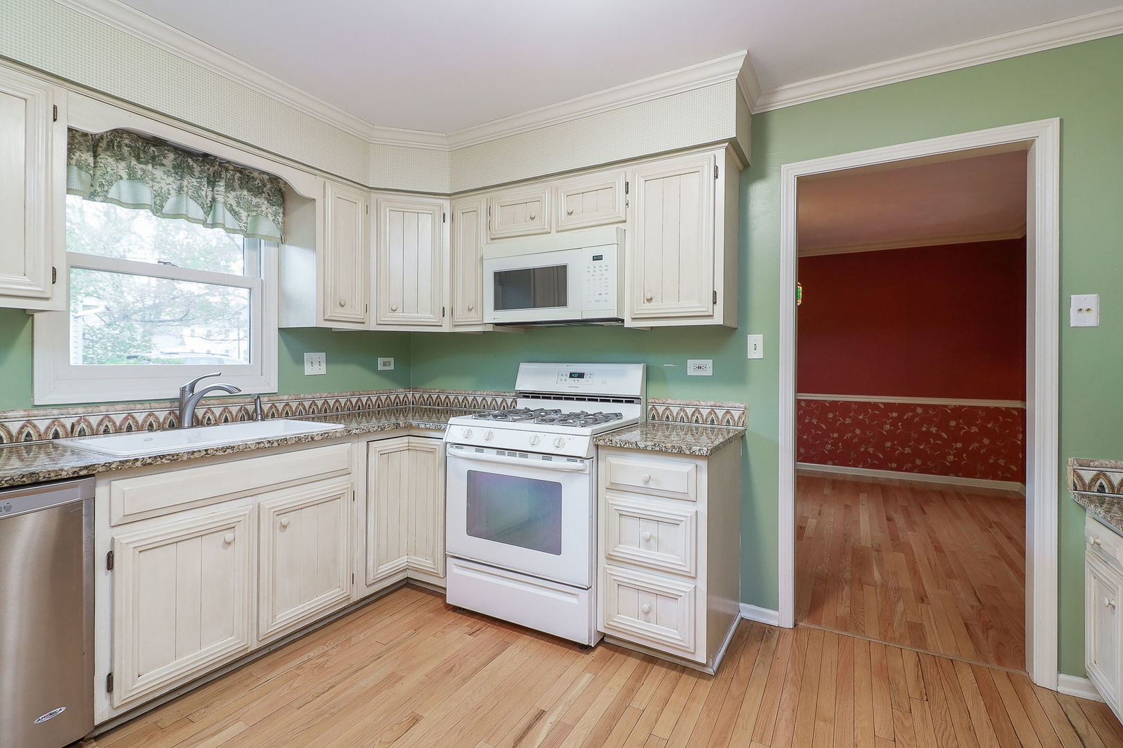523 Cassin Road Naperville, IL 60565 - Photo 8 of 26 a kitchen with stainless steel appliances granite countertop a sink and cabinets with wooden floor