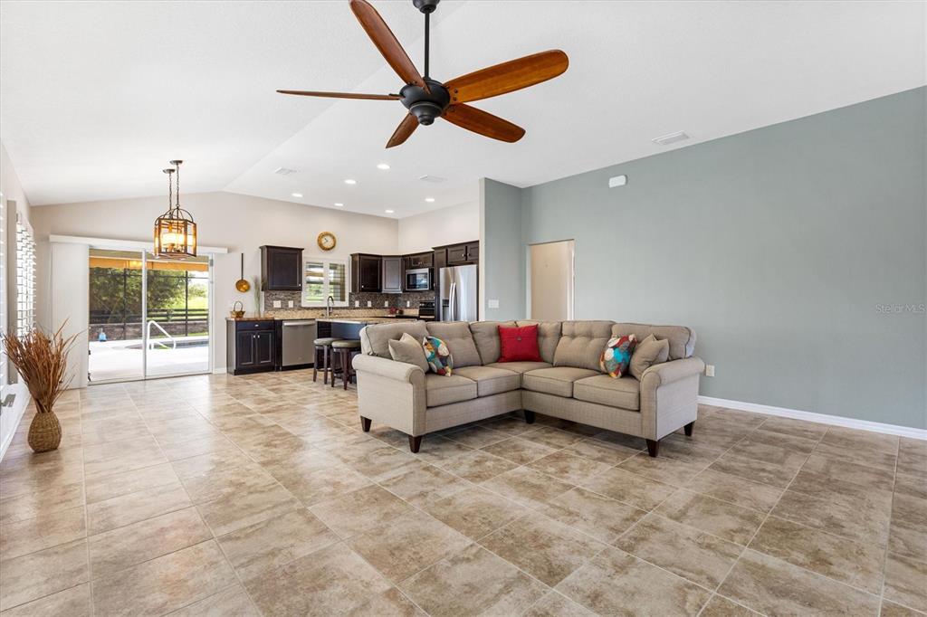 7351 Southeast 169th Cote Loop The Villages, FL 32162 - Photo 7 of 32 a living room with furniture and kitchen view