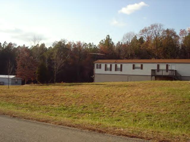2420 Brookside Road Axton, VA 24054 - Photo 1 of 5 a house with trees in the background