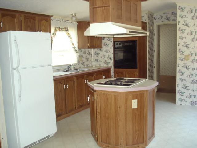 2420 Brookside Road Axton, VA 24054 - Photo 2 of 5 a kitchen with a sink and a refrigerator