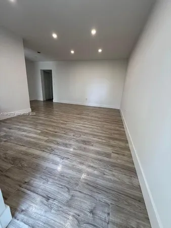 a view of room with wooden floor