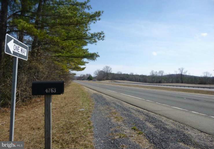 4763 Winchester Road The Plains, VA 20198 - Photo 2 of 12 a street sign on a sidewalk next to a road