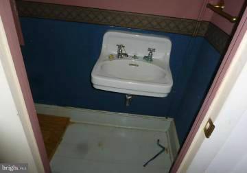4763 Winchester Road The Plains, VA 20198 - Photo 4 of 12 a bathroom with a sink and mirror