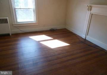 4763 Winchester Road The Plains, VA 20198 - Photo 6 of 12 an empty room with wooden floor and windows