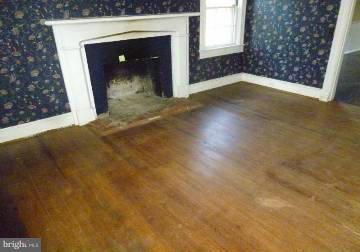 4763 Winchester Road The Plains, VA 20198 - Photo 10 of 12 a view of a livingroom with wooden floor and a fireplace
