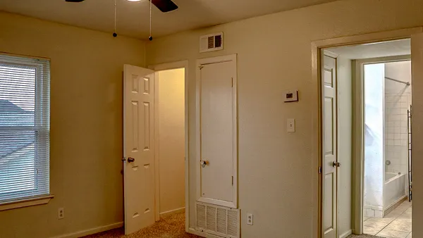 a view of a bathroom with a shower and closet