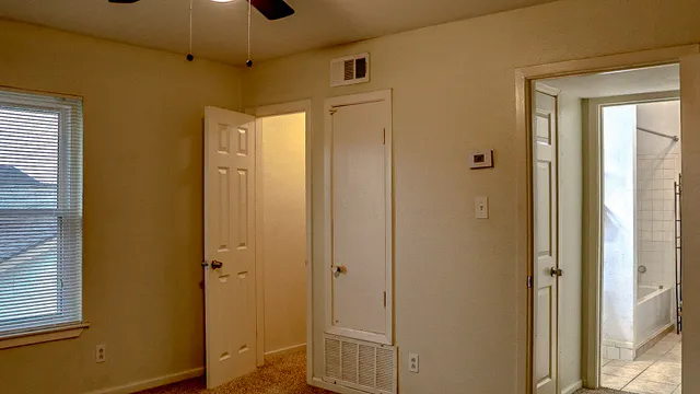 a view of a bathroom with a shower and closet