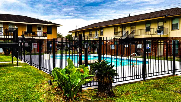 a view of swimming pool with a garden and deck