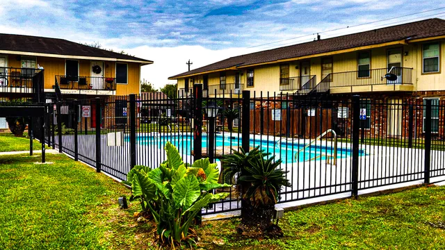 a view of swimming pool with a garden and deck