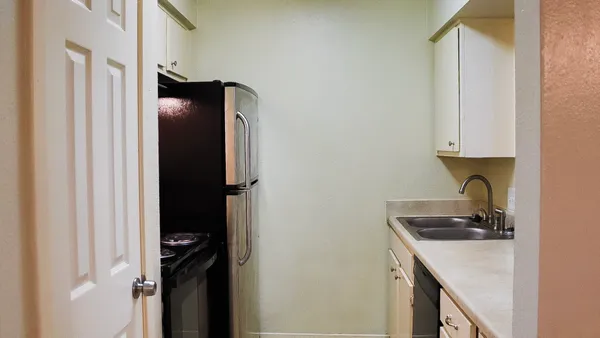 a kitchen with a refrigerator and cabinets