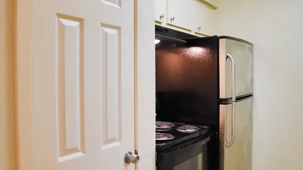 a kitchen with a refrigerator and a stove