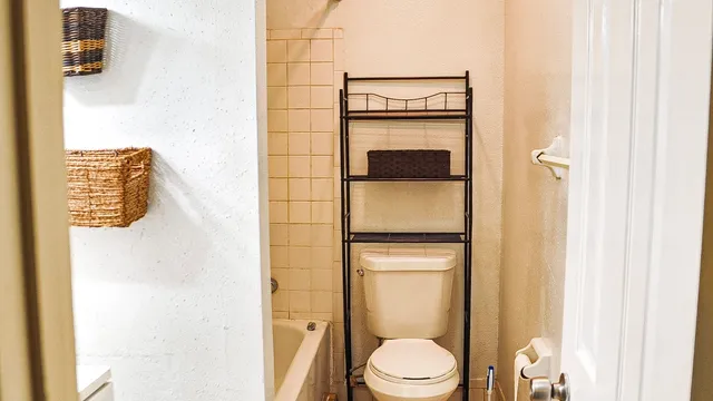 a bathroom with a toilet and a shower