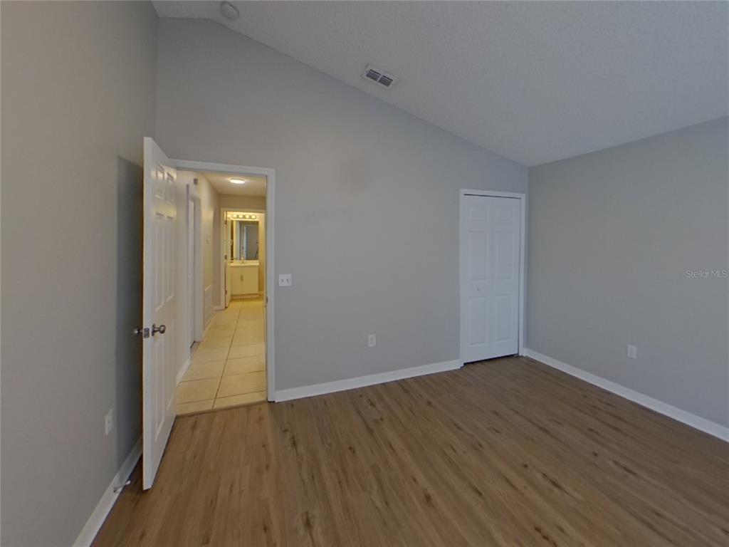 Undisclosed Address Riverview, FL 33578 - Photo 13 of 15 a view of an empty room with wooden floor and a window