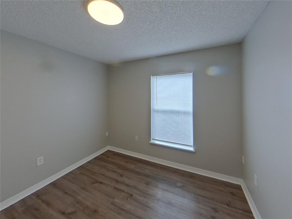 Undisclosed Address Riverview, FL 33578 - Photo 10 of 15 an empty room with wooden floor and windows