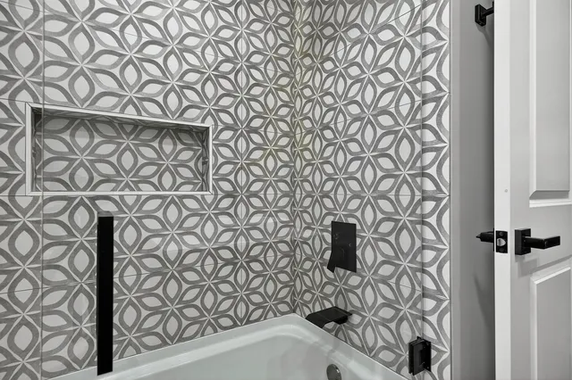 a bathroom with a bathtub and shower