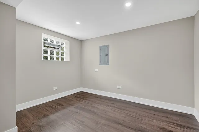 a view of an empty room with wooden floor