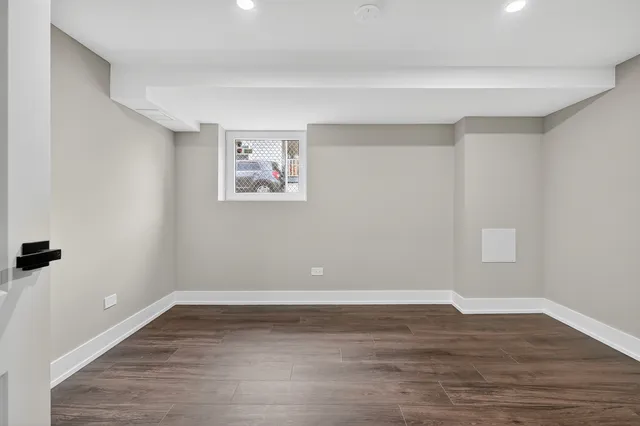 a view of a room with wooden floor and window