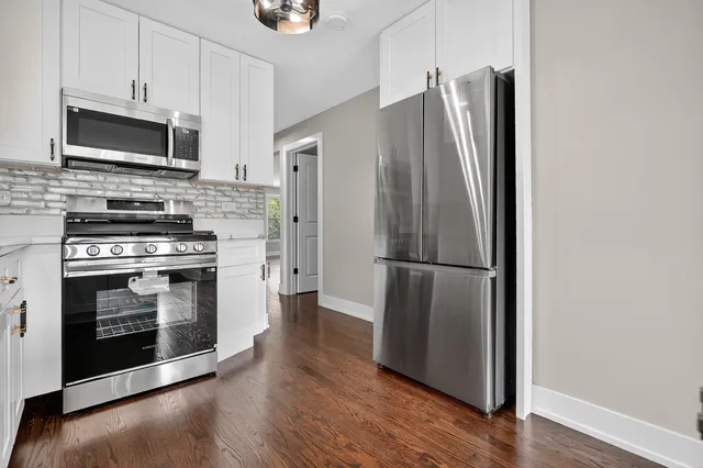 a kitchen with a refrigerator stove and microwave