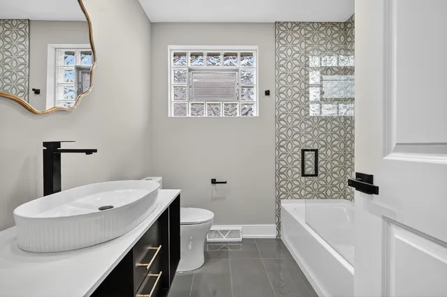 a bathroom with a bathtub a sink and a toilet