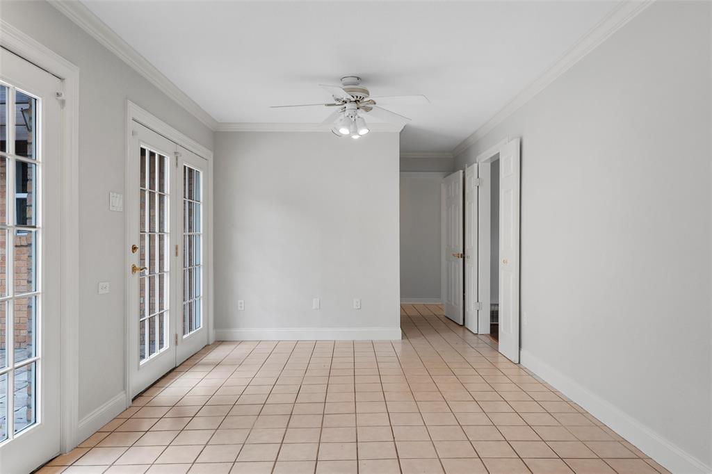 2131 Mountainview Drive Waco, TX 76710 - Photo 10 of 27 Unfurnished room featuring ornamental molding, light tile patterned floors, and a ceiling fan