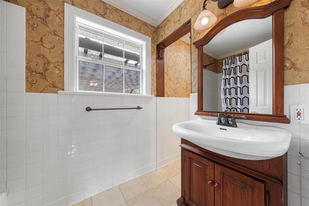 2131 Mountainview Drive Waco, TX 76710 - Photo 17 of 27 Bathroom with wallpapered walls, light tile patterned flooring, vanity, curtained shower, and ornamental molding