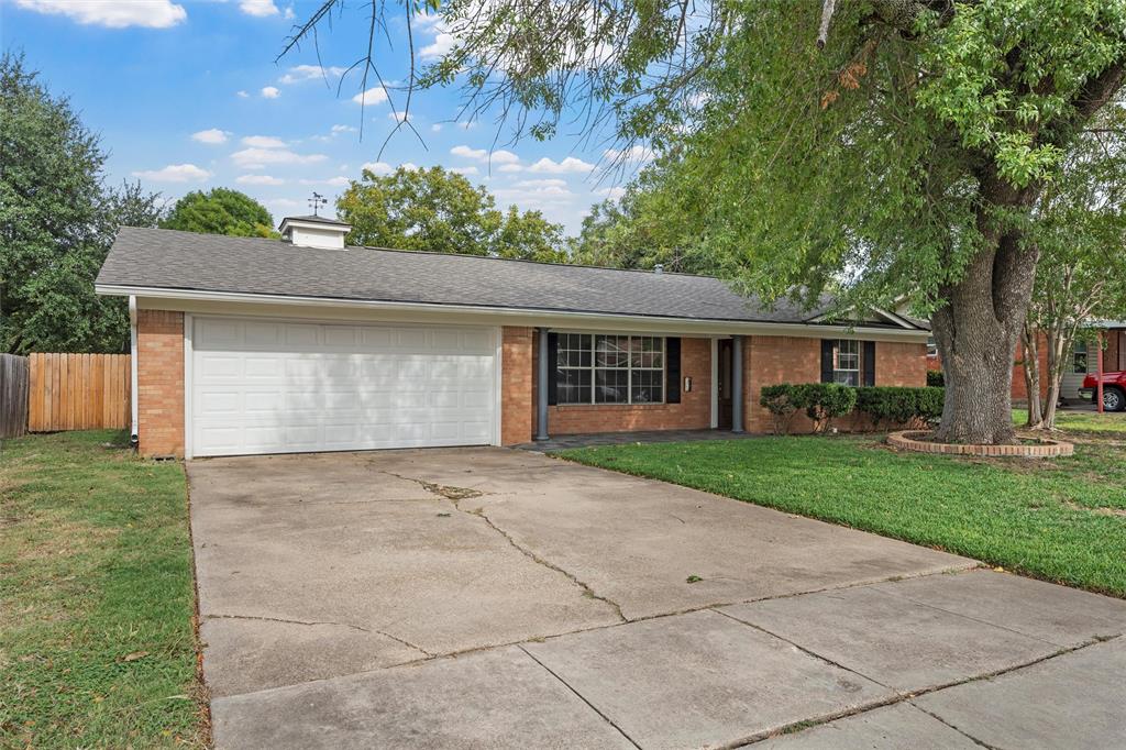 2131 Mountainview Drive Waco, TX 76710 - Photo 2 of 27 Ranch-style home with brick siding, concrete driveway, roof with shingles, an attached garage, and a chimney