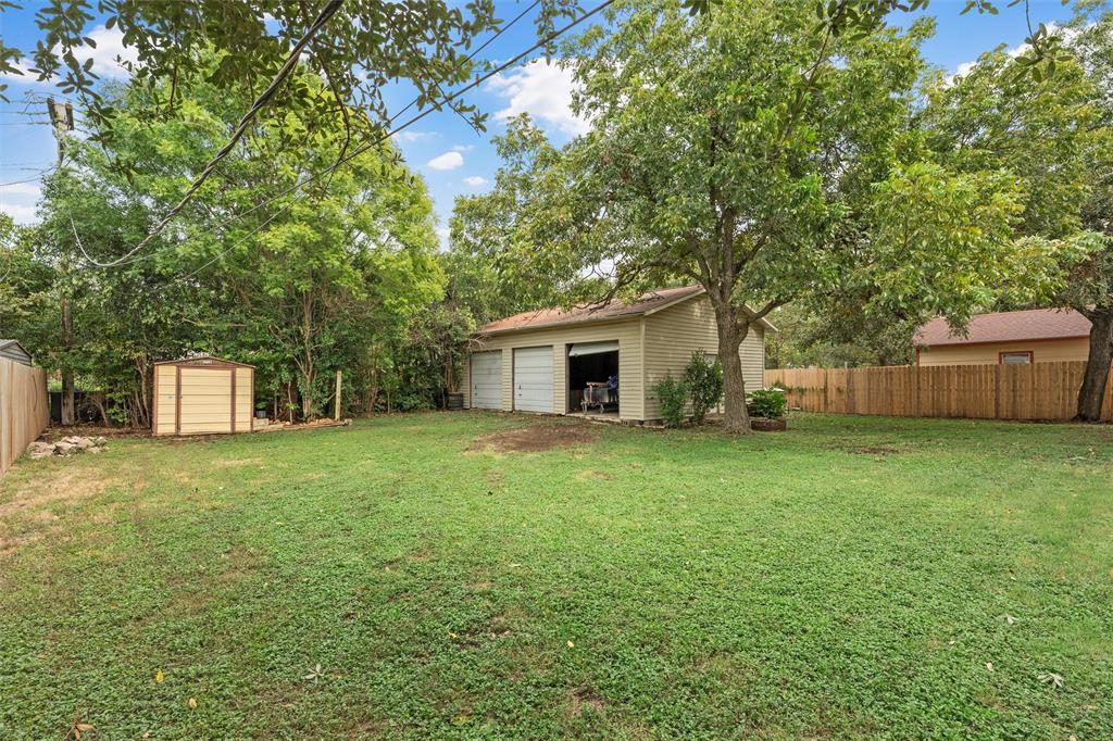 2131 Mountainview Drive Waco, TX 76710 - Photo 23 of 27 View of yard featuring a detached garage and a storage unit