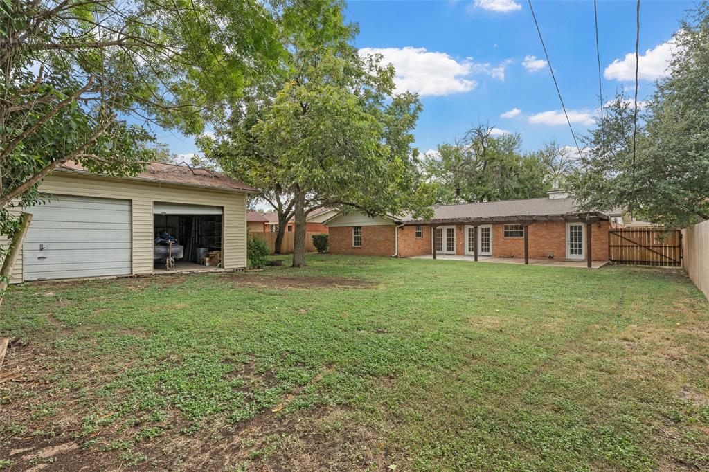 2131 Mountainview Drive Waco, TX 76710 - Photo 24 of 27 Fenced backyard with a patio area, a garage, french doors, and an outbuilding