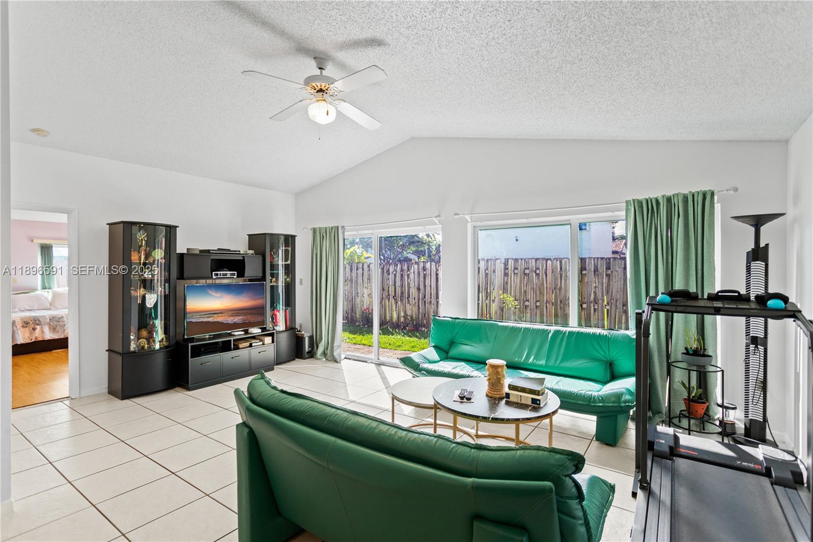 6090 Northwest 179th Terrace Hialeah, FL 33015 - Photo 13 of 29 a living room with furniture and a flat screen tv
