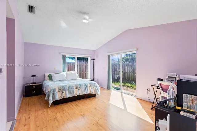 a bedroom with a bed and large window