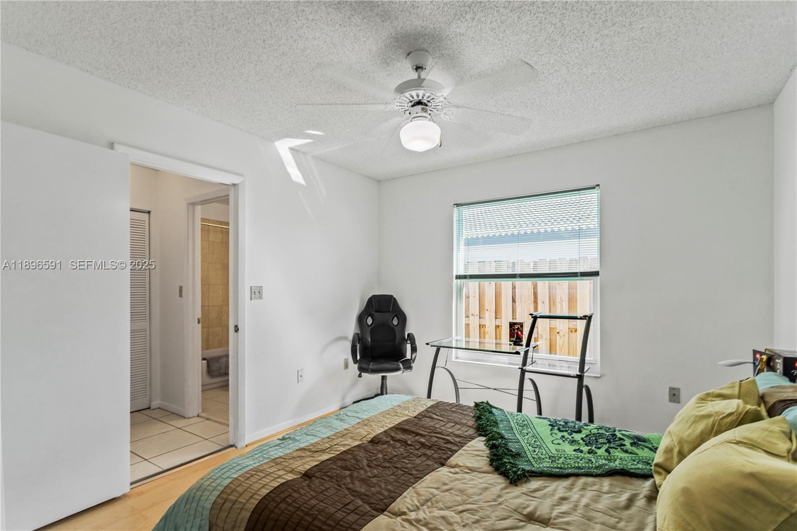 6090 Northwest 179th Terrace Hialeah, FL 33015 - Photo 19 of 29 a bedroom with a bed and a window