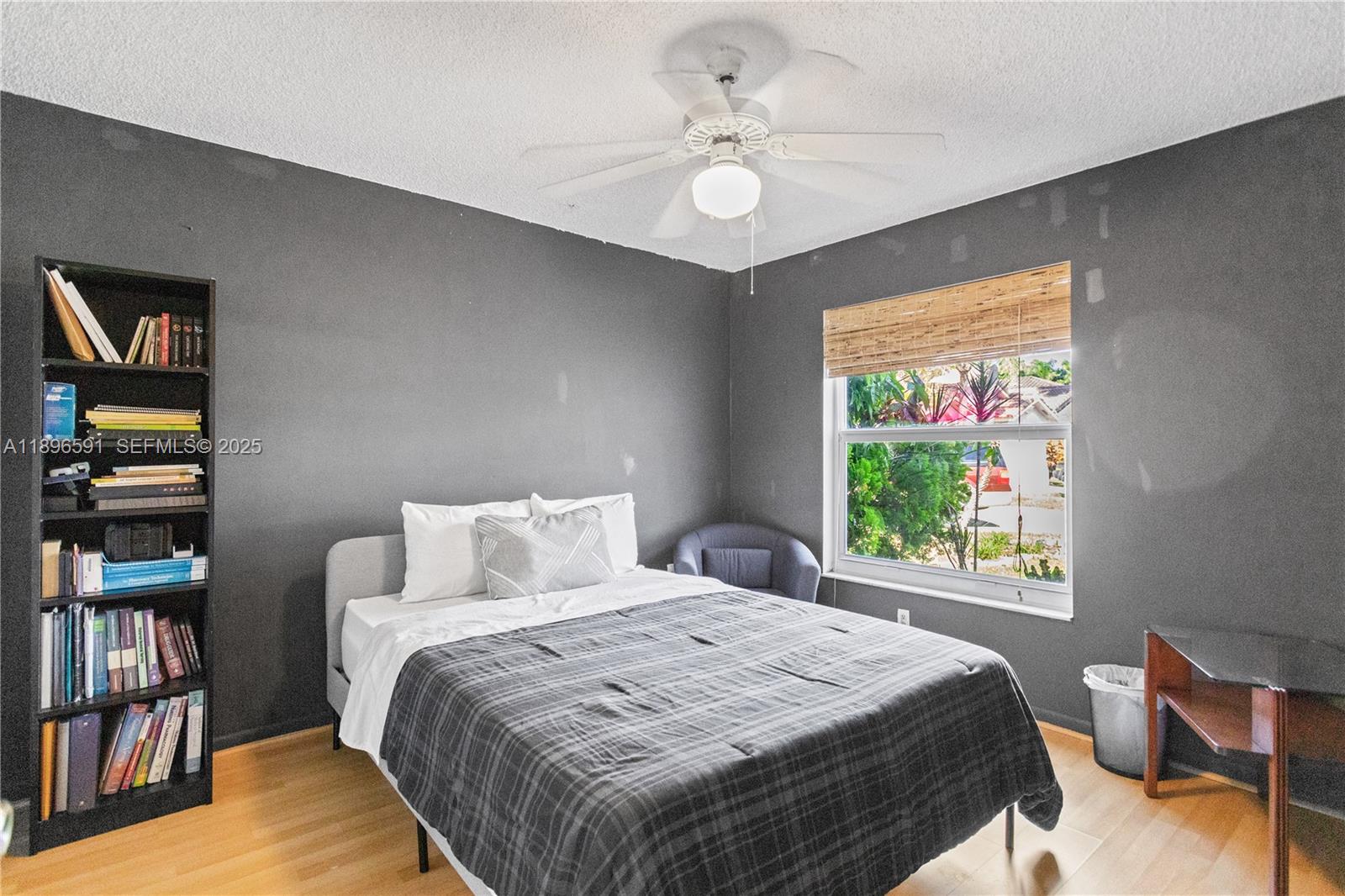 6090 Northwest 179th Terrace Hialeah, FL 33015 - Photo 20 of 29 a bedroom with a large bed and a book shelf