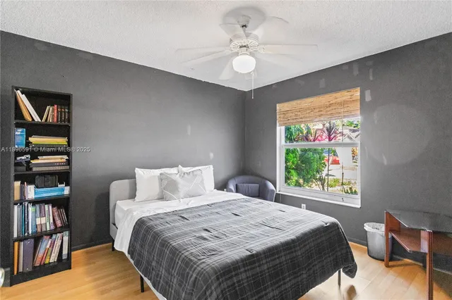 a bedroom with a large bed and a book shelf