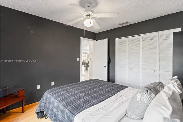a bedroom with a large bed and a chandelier