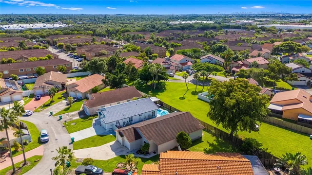 an aerial view of residential houses with outdoor space and river