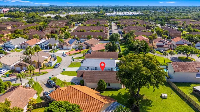an aerial view of a houses with a yard