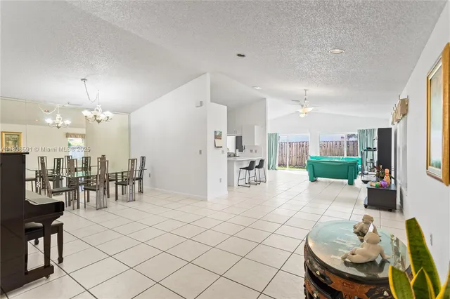 a living room with furniture and kitchen view