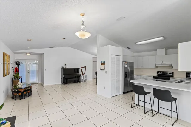 a kitchen with stainless steel appliances a stove a refrigerator and a sink