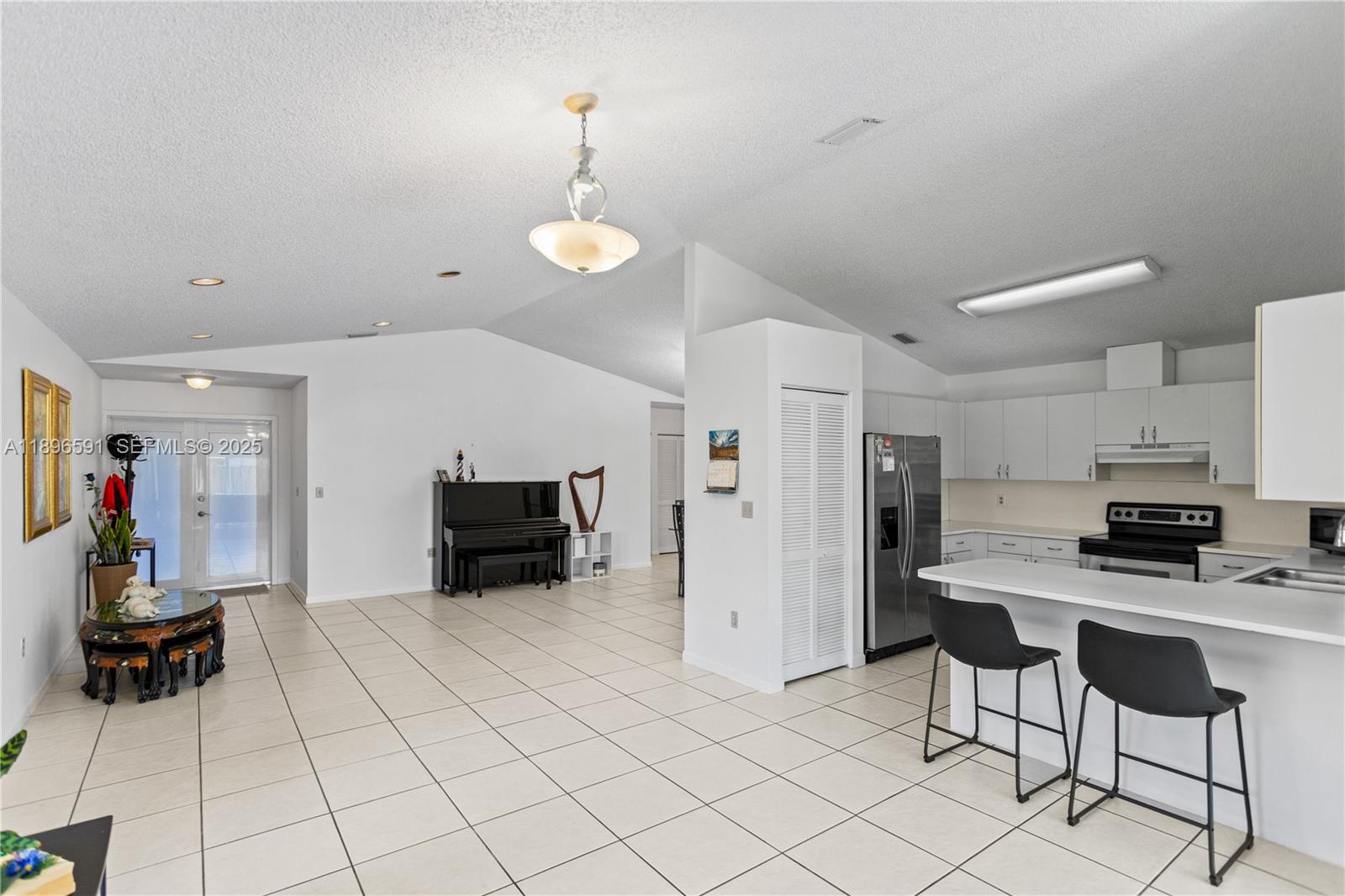 6090 Northwest 179th Terrace Hialeah, FL 33015 - Photo 7 of 29 a kitchen with stainless steel appliances a stove a refrigerator and a sink