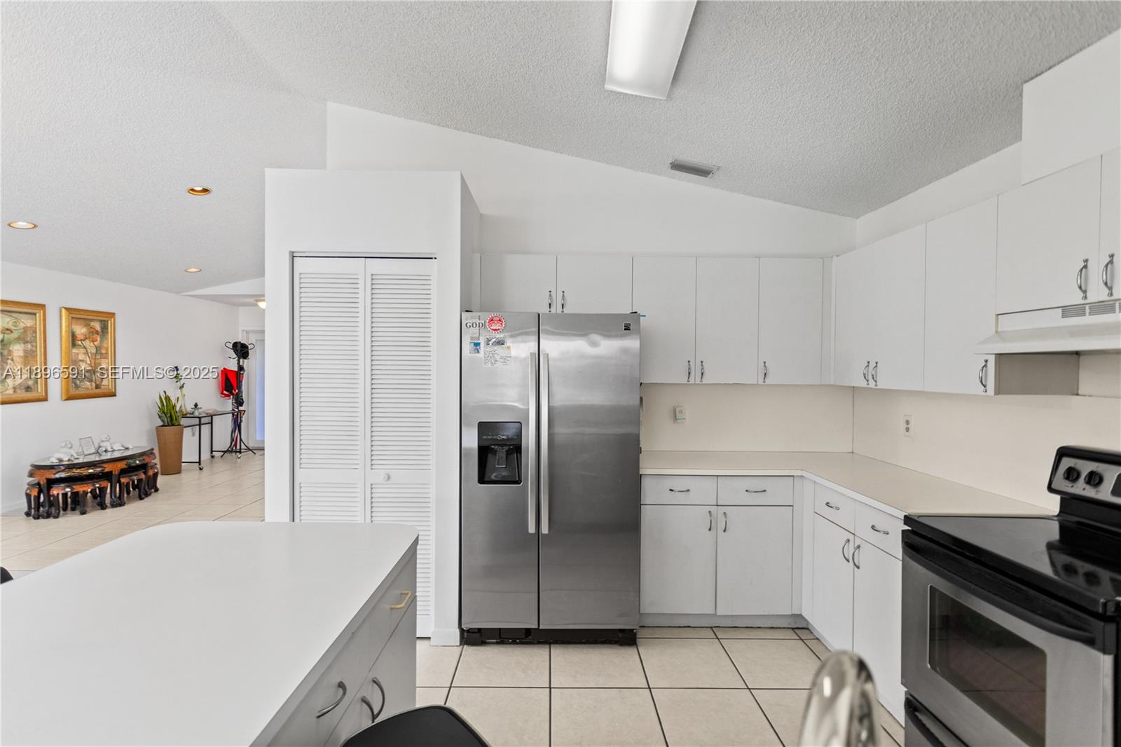 6090 Northwest 179th Terrace Hialeah, FL 33015 - Photo 9 of 29 a kitchen with a sink a refrigerator and cabinets