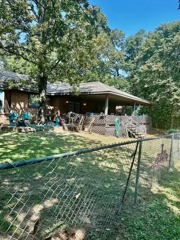 a view of house with backyard outdoor seating and green space