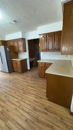 a view of a room with wooden floor