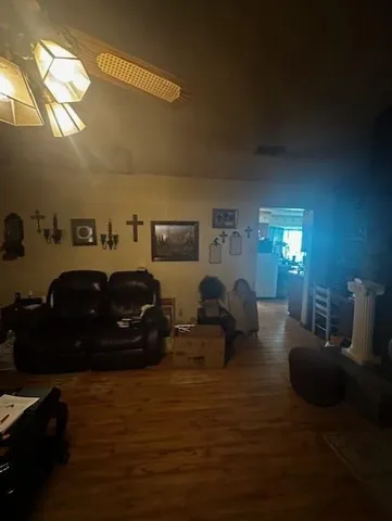 a living room with furniture a lamp and a window