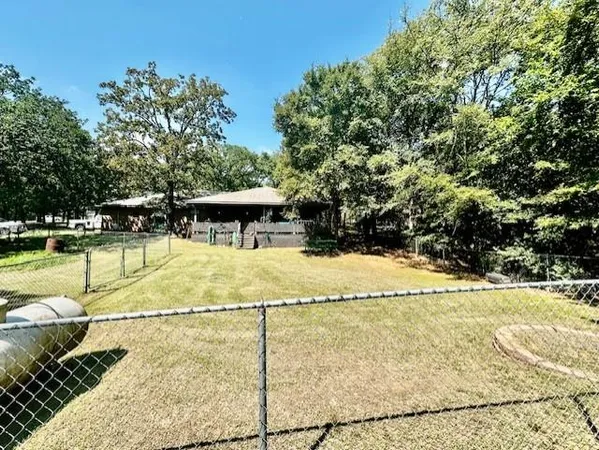 a view of a swimming pool with a yard